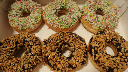 Photo of donut topped with chocolate peanut and colorful meses