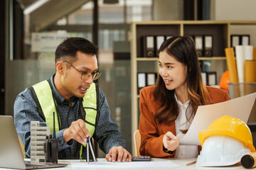 A middle-aged man, a young woman, and other Asian individuals collaborate on architectural engineering for condos and apartments, focusing on sustainable renovation and green energy solutions.