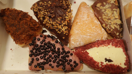 Photo of triangular sweet buns with various toppings and flavors
