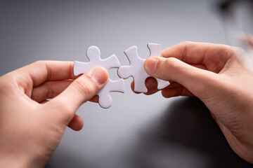 Hands Connecting Puzzle Pieces - Concept of Teamwork