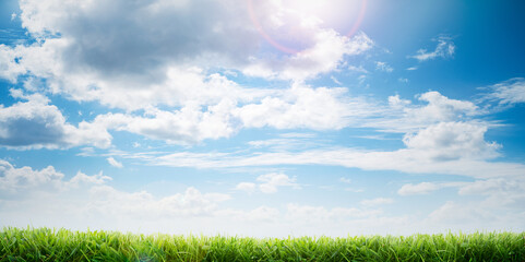 A bright fresh sunny spring, summer blue sky background with white fluffy clouds and freshly cut...