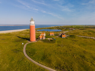 A majestic lighthouse stands tall near the endless ocean, casting its guiding light over the waters...