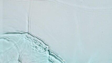 Water surface texture top view. Water waves blue colored. Sun and shadows. Pure blue water with reflections sunlight in slow motion. Motion clean swimming pool ripples and wave. 4k. High quality - Powered by Adobe