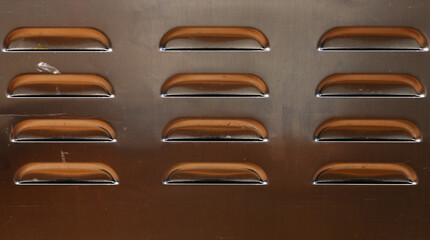 Slots.  12 ventilation slots in a metal cabinet.
