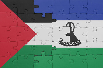 puzzle with the colourful national flag of lesotho and flag of palestine.