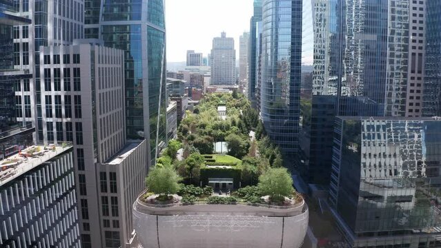 Wide reverse pullback aerial shot of Salesforce Park on the roof of the Transbay Transit Center in downtown San Francisco, California. 4K