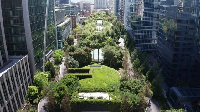 Aerial low tilting up shot over the urban green Salesforce Park atop the Transbay Transit Center in San Francisco, California. 4K