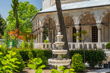 Water fountain fountain in the garden of the historical Süleymaniye Mosque. and arched columns...