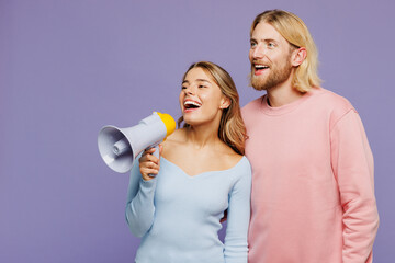 Young couple two friends family man woman wear pink blue casual clothes together hold megaphone...