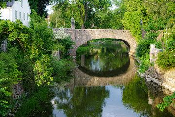 Naklejka premium View of a old stone bridge over a canal in city