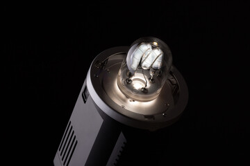 Flashing studio strobe. Light of strobe and modeling lamp. Photography studio flash isolated.