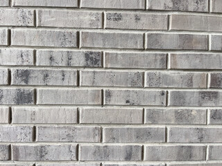 The background of a brick gray wall. Gray brick.