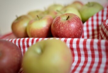 Organic apples on red check pattern cloth 