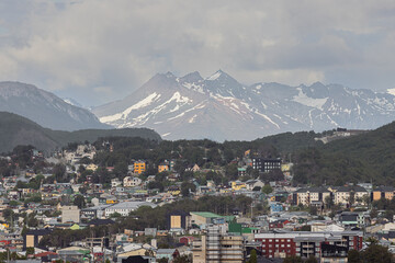 Ushuaia with snow capped mountains in the background, seen from the harbor