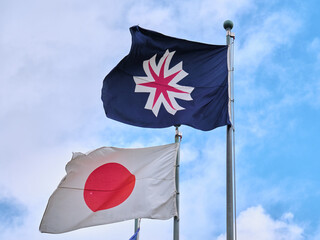 風にたなびく北海道旗と日章旗 / The Hokkaido flag and the Japanese flag fluttering in...