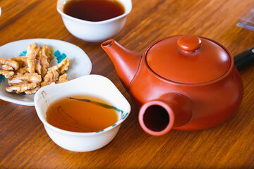 Very Old Chinese TeaPot with Tea Pouring in a small bowls Tea Tasting Ceremony Preserved Black Tea