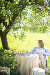 breakfast in the garden in summer food on the table, eggs buns and coffee