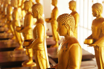 Golden Buddha statue arrange in the temple Bangkok Thailand