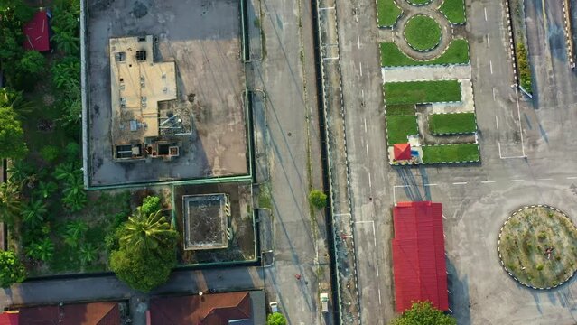 Aerial vertical flyover and around driving training institution next to cemetery at Seri Manjung, Perak, Malaysia, driving course designed for learners to practice and develop different skills.