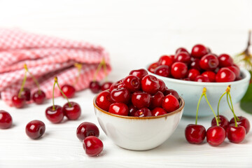 Cherries. Fresh ripe cherries with leaves on a textured wooden background. Fresh sweet organic cherry pile. Berries and fruits. Vegan. Healthy eating. Place for text. Copy space