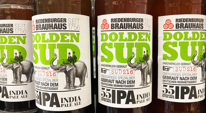Viersen, Germany - May 9. 2024: Closeup of bottles Riedenburger  Dolden Sud india pale ale IPA beer brewed according to german purity law, 55 bitterness IBU units (focus on center)
