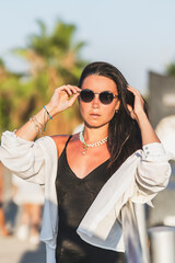 Woman in black dress and sunglasses
