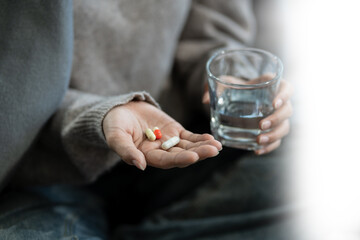 medicine, Sad and depressed young female sitting on the sofa, sad mood, feel tired, lonely and unhappy concept.
