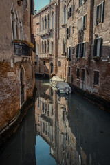 view of reflected venetian houses with a boat 