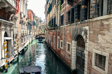Fototapeta premium motorboat moving in narrow venetian canal 