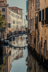 old venetian houses reflected in canal