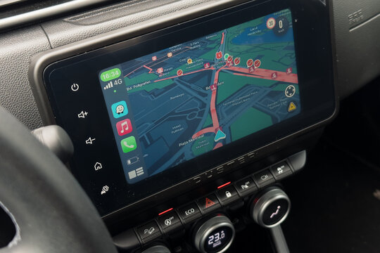 Bucharest, Romania - 30 May 2024: Standstill traffic in Bucharest. Close up photo of the Waze Apple Carplay display in a car while staying in standstill traffic rush hour because of the weather