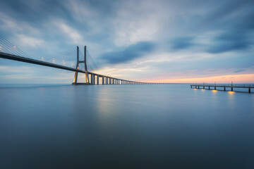 Vasco da Gama bridge and pier over tagus river in Lisbon (Portugal), before sunrise