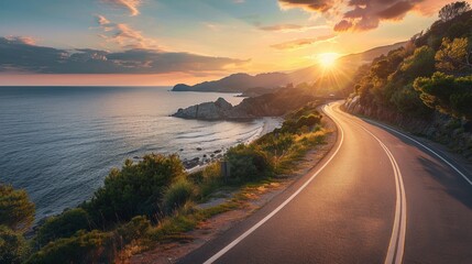A scenic view of a road alongside the sea captured at sunrise