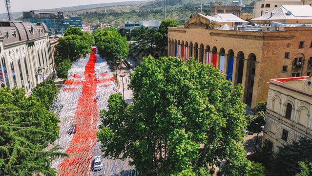 Independence Day in Georgia in may 26, Rustaveli Aveniu and Ribbons in the colors of the flag in front of the Parliament - Powered by Adobe