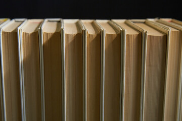 Books on dark background, white books stacked on black background