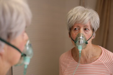 Mature female using a mask to improve her breathing issues 
