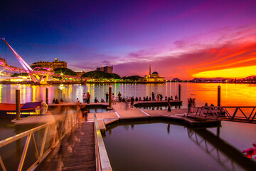 the view of the river and pier at dusk which is red which attracts visitors to the pier