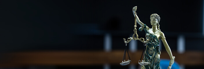 Statuette of justice, the blindfolded girl with scales. Concept of law