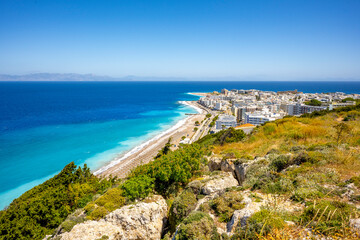 Aegean beach with sunshades in city of Rhodes (Rhodes, Greece)