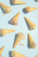 Ice cream melt on blue background. Summer aesthetic sweet food concept. 