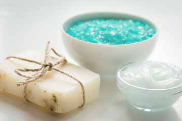 blue set for bath with salt and cream on white table background