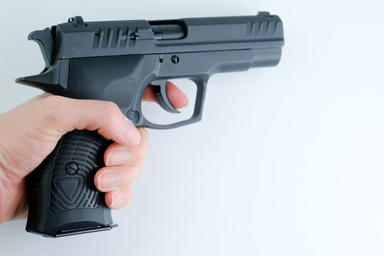 An woman holding a gun, ready for action