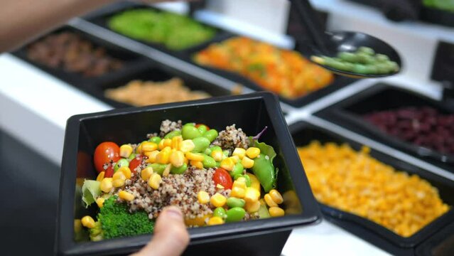 Closeup hands collecting healthy lunch from fresh vegetables and herbs. Ingredients in salad is beneficial contribution to health. Healthy choice for those who value taste and take care of themselves