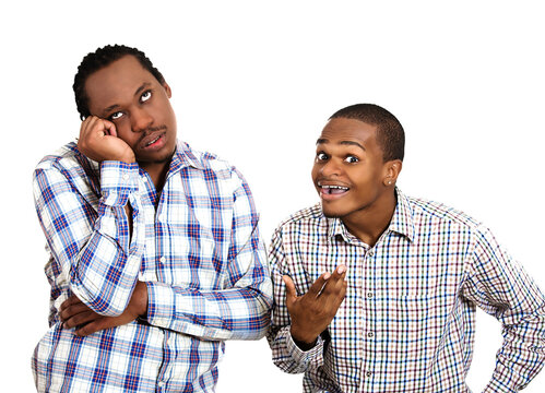 Closeup portrait two guys, one being excited, optimistic, and another one bored, annoyed  standing next to each other, isolated white background. 