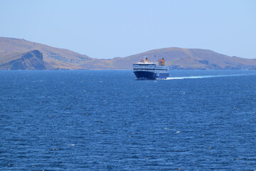 blue ferryboat crossing the blue sea - near Lemnos island, Greece, aegean sea