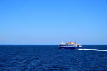 blue ferryboat crossing the blue sea - near Lemnos island, Greece, aegean sea