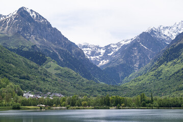 Snow-capped mountains above Génos-Loudenvielle lake in French Pyrenees. 