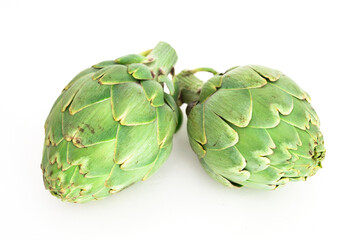 Two ripe artichokes on white background