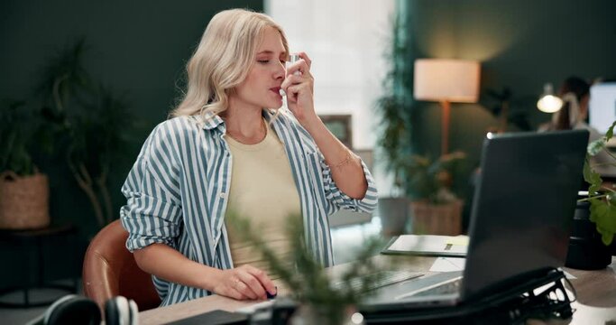 Woman, asthma and inhaler for health, breathing or allergy attack in creative business startup office by laptop. Sick, lung disease or spray medicine for problem, chest pain or treatment for wellness