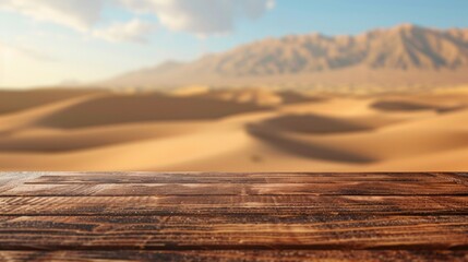 A wooden brown table top with blur background of desert dune mountain.